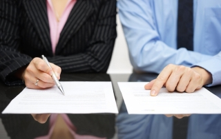 Businessman and business woman inspecting documents, business organization, business attorney