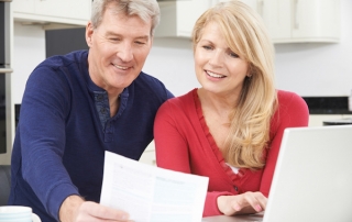 Smiling Mature Couple Reviewing Document, estate planning attorney, estate planning terms