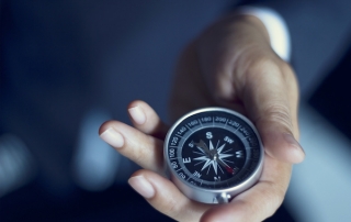 Businessman with a compass holding in hand, color tone film look